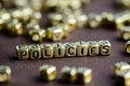 Word POLICIES made from small golden letters on the brown background, selective focus