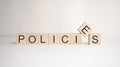 The word policies is written on wooden cubes on a light background. Business concept