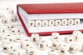 Word Politics written in wooden blocks in red notebook on white