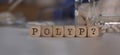 Word POLYP and question mark composed of wooden dices. Pills, documents and a pen in the background Royalty Free Stock Photo