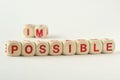 The word possible written with wood blocks - Changing impossible