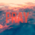 The word pray on the Red Sky blured background