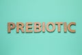 Word Prebiotic made of wooden letters on turquoise table, flat lay