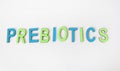 The word PREBIOTICS is written in colored wooden letters