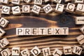 word pretext composed of wooden cubes with letters Royalty Free Stock Photo