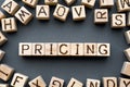 word pricing composed of wooden cubes with letters