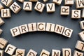 word pricing composed of wooden cubes with letters