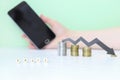 The word pricing, which is assembled from cubes in the foreground and a blurry black arrow on coins and a smartphone