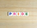 Word Pride on wood background