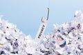 Word Privacy hooked on fishing hook pulled from pile of shredded documents