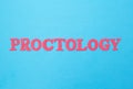 The word proctology on a blue background. Concept section of medicine dealing with the treatment of the anus, hemorrhoids and Royalty Free Stock Photo