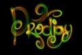 The word prodigy made by green and red fire or smoke isolated over black background