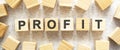 The word PROFIT consists of wooden cubes with letters, top view on a light background Royalty Free Stock Photo