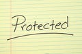 Protected On A Yellow Legal Pad Royalty Free Stock Photo