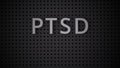 Word PTSD spelled out with white letters on a gray pegboard