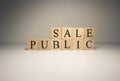 The word public sale from wooden cubes. Photographs were taken in the spotlight