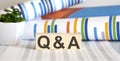 Word Q and A made with wood building blocks on chart background
