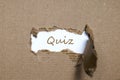 The word quiz appearing behind torn paper. Royalty Free Stock Photo