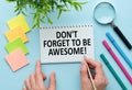 Word quotes of DON'T FORGET TO BE AWESOME on colorful memo papers with blue background