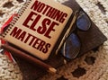 Word quotes of NOTHING ELSE MATTERS on notebook, glasses, pen. Business startup concept Royalty Free Stock Photo