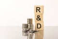 RD - text on wooden cubes on white background with coins Royalty Free Stock Photo