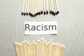 Word Racism and different matches on light grey table, flat lay Royalty Free Stock Photo