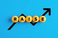 The word raise written on yellow balls with increasing line chart Royalty Free Stock Photo