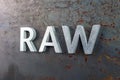 The word raw laid with silver metal letters on hot rolled steel sheet surface Royalty Free Stock Photo