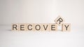 The word recovery is written on wooden cubes on a light background. Business concept