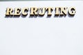 The word recruiting is written in wooden letters on a white background, the concept of hiring employees, recruitment in business