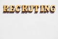 The word recruiting is written in wooden letters on a white background, the concept of hiring employees, recruitment in business