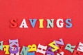 SAVINGS word on red background composed from colorful abc alphabet block wooden letters, copy space for ad text. Learning english Royalty Free Stock Photo