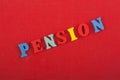 PENSION word on red background composed from colorful abc alphabet block wooden letters, copy space for ad text. Learning english Royalty Free Stock Photo