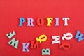 PROFIT word on red background composed from colorful abc alphabet block wooden letters, copy space for ad text. Learning english Royalty Free Stock Photo