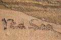 Word Red Sea written in the sand on the beach.  Summer travel concept Royalty Free Stock Photo