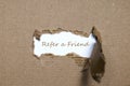 The word refer a friend appearing behind torn paper. Royalty Free Stock Photo