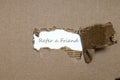 The word refer a friend appearing behind torn paper. Royalty Free Stock Photo