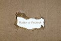 The word refer a friend appearing behind torn paper. Royalty Free Stock Photo