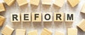 The word REFORM consists of wooden cubes with letters, top view on a light background Royalty Free Stock Photo