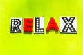 Word relax of black and red letters on a green background