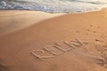 Word Relax written on sandy beach in summer Royalty Free Stock Photo