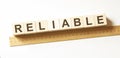 Word RELIABLE made with wood building blocks Royalty Free Stock Photo