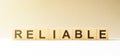 Word RELIABLE made with wood building blocks Royalty Free Stock Photo