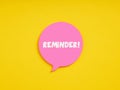 The word reminder on pink speech bubble on yellow background. Important information, task, appointment or memo reminder