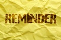 Word REMINDER written on crumpled paper