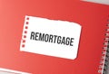 The word remortgage on torn paper on red notepad