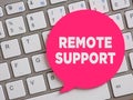 The word remote support on speech bubble over computer keyboard