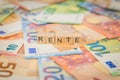 The word Rente - in German for annuity - on banknotes Euro notes written with wooden cube