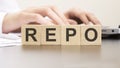 man made word REPO with wood blocks on the background of the office table. selective focus. business concept.