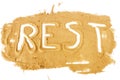 Word REST written on pile of yellow sand Royalty Free Stock Photo